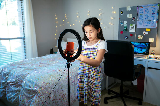 Girl Setting Up Cell Phone In Ring Light To Make Video For Tiktok Social Media Video In Bedroom 