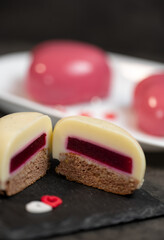 vanilla moose cake cut in half in the shape of a heart on ardesia