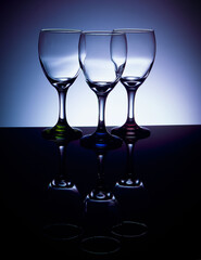 Empty wine glasses with colored stems
