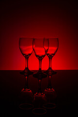 Empty wine glasses with red background