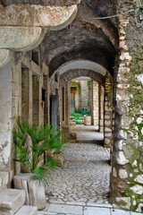 Fototapeta na wymiar A narrow street between the old houses of Guardia Sanframondi, a medieval village in the province of Salerno, Italy.