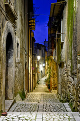 A narrow street between the old houses of Guardia Sanframondi, a medieval village in the province of Salerno, Italy.