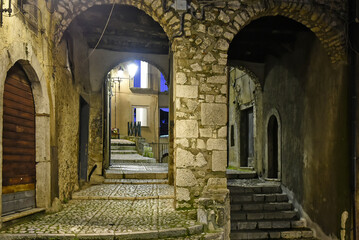 Naklejka premium A narrow street between the old houses of Guardia Sanframondi, a medieval village in the province of Salerno, Italy.