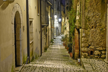 A narrow street between the old houses of Guardia Sanframondi, a medieval village in the province of Salerno, Italy.
