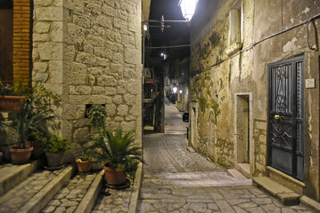 A narrow street between the old houses of Guardia Sanframondi, a medieval village in the province of Salerno, Italy.