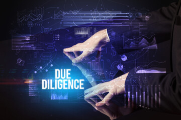 Businessman touching huge screen with DUE DILIGENCE inscription, cyber business concept