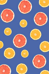 Lemon, orange and grapefruit on a blue background, cut in half and sorted by size. Flat lay.
