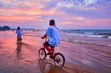 Cyclers on the beach, Chaung Tha, Myanmar