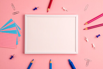 Mockup of pen, sticky note, notepad, marker, eraser, push pins, paper clip pencils on pink background. Flat lay top view. Education template back to school and online study concept with copy space.