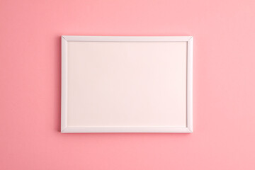 Mockup of white frame on pink background. Flat lay top view. Education template back to school and online study concept with copy space