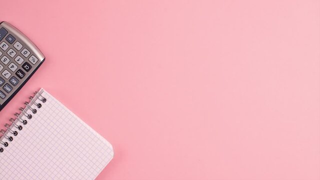 Stop motion animation mockup of calculator, notepad on pink background. Flat lay top view banner. Education template back to school and online study concept with copy space