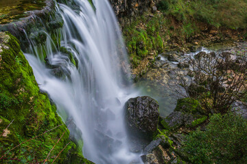Naklejka premium Beautiful waterfall in the mountains of Serra de Aire, Portugal. Long exposure of the waterfall of Fornea in Porto de Mos, Portugal. 