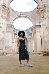 Fototapeta na wymiar Young woman on vacation visiting famous ancient ruins in Antigua Guatemala - young traveler enjoying her vacation visiting famous monuments