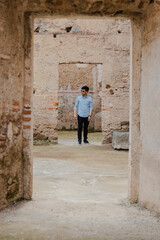 Hispanic young man on vacation visiting famous ancient ruins in Antigua Guatemala - young traveler discovering new places