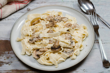 Fancy organic fetuccine pasta with creamy alfredo mushroom sauce