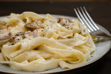 Fancy organic fetuccine pasta with creamy alfredo mushroom sauce