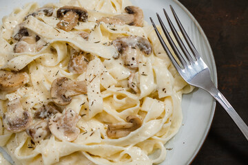 Fancy organic fetuccine pasta with creamy alfredo mushroom sauce