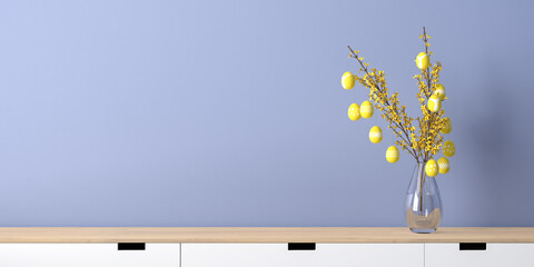 Interior design mockup - easter eggs hanging on a forsythia twig in a glass vase with water. Vase standing on a sideboard. Blue wall. Easter eggs in illuminated yellow with different patterns.