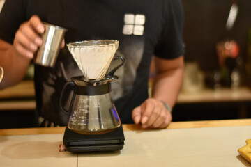 Barista cafe Prepare espresso and vietnam coffee drinks at the coffee shop. portrait of a coffee shop employee making coffee at the bar. the process of making warm drinks with a vintage color concept