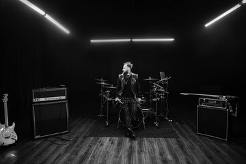 brutal portrait of a man musician with a beard and in black clothes on the background of musical...
