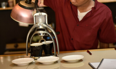 Barista cafe Prepare espresso and vietnam coffee drinks at the coffee shop. portrait of a coffee shop employee making coffee at the bar. the process of making warm drinks with a vintage color concept