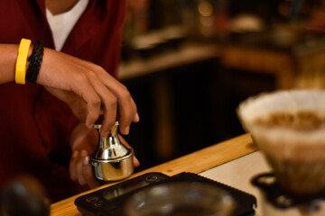 Barista cafe Prepare espresso and vietnam coffee drinks at the coffee shop. portrait of a coffee shop employee making coffee at the bar. the process of making warm drinks with a vintage color concept