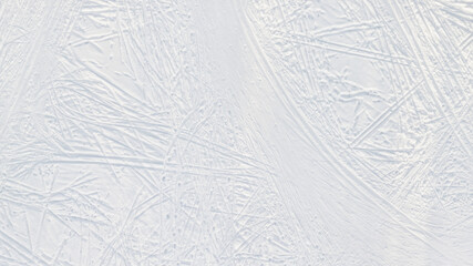 Snow-covered ice with ski tracks large top aerial view