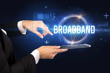 Close-up of a touchscreen with BROADBAND inscription, new technology concept