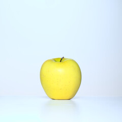 golden delicious apple on a white kitchen table