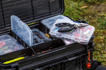 A large fisherman's tackle box fully stocked with lures and gear for fishing.fishing lures and...
