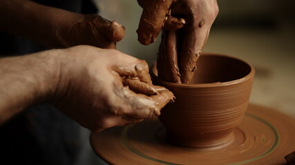 Woman using potters wheel in pottery. Masters making handmade product