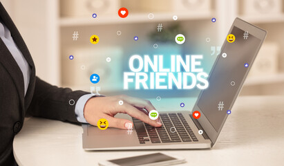 Freelance woman using laptop with ONLINE FRIENDS inscription, Social media concept