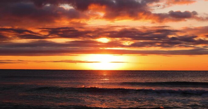 Ocean sunrise. Tropical island beach and dramatic clouds