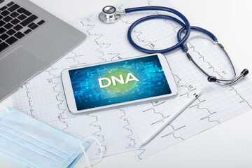 Close-up view of a tablet pc with DNA abbreviation, medical concept