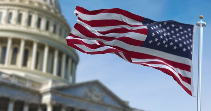 American flag waving with the US Capitol Hill blurred in the background