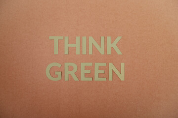 Think Green cardboard letters on a craft paper