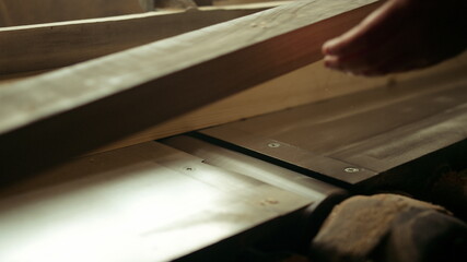 Carpenter preparing wooden plank for product indoor. Guy grinding wood in studio