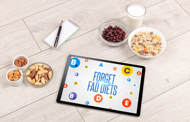Healthy Tablet Pc compostion with FORGET FAD DIETS inscription, weight loss concept