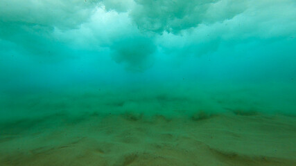 Underwater shot of the sea surface with waves on a sunny day
