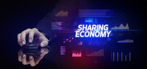 hand holding wireless peripheral with SHARING ECONOMY inscription, cyber business concept