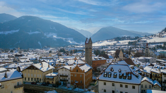 Twelve o'clock Tower in Vipiteno - Sterzing: is a little town in South Tyrol in Wipptal, northern Italy. Aerial view of the old city center with "Torre delle Dodici" in winter time and snowy roofs.