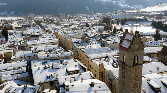Twelve o'clock Tower in Vipiteno - Sterzing: is a little town in South Tyrol in Wipptal, northern Italy. Aerial view of the old city center with "Torre delle Dodici" in winter time and snowy roofs.