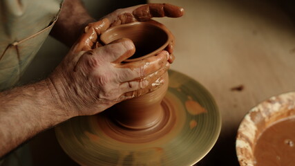 Artist hands sculpting product in pottery. Man making clay product in workshop