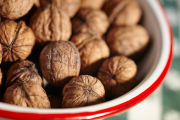 A bowl of English Walnuts in their shells
