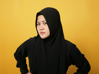 Portrait of cynical Asian muslim woman with suspicious expression looking and starring, mistrust...