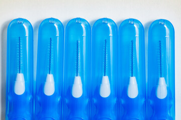 Fototapeta premium Blue with white interdental brushes. Oral hygiene. Brush your teeth thoroughly. Interdental-Sticks
