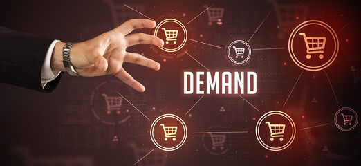 Close-Up of cropped hand pointing at DEMAND inscription, online shopping concept