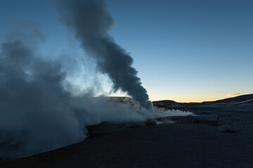 Volcanic activity at sunrise with fumarole and geyser steam in the Andes mountains, Sol de Manana, Uyuni, Bolivia.