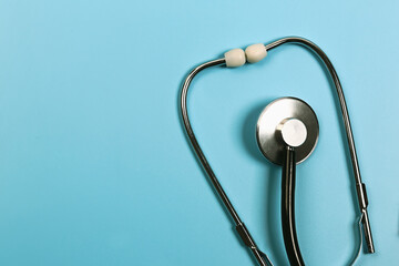 Medical concept. Stethoscope on a blue background. Flat style, top view.
