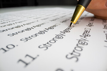 Close-up view of completing a questionnaire